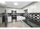 Updated kitchen featuring white cabinets, stainless steel appliances, and black countertops at 2338 Malibu Ct, Anderson, IN 46012