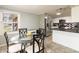 Eat-in kitchen with stainless steel appliances and black and white checkered backsplash at 2338 Malibu Ct, Anderson, IN 46012