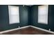 Dark green walls and hardwood floors in bedroom at 302 E Cowing Dr, Muncie, IN 47303