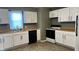 White kitchen with wood countertops and black appliances at 302 E Cowing Dr, Muncie, IN 47303