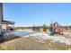 Backyard with playground set and trampoline in winter at 4416 Voyageur Way, Carmel, IN 46074