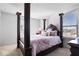 Luxurious bedroom with a four-poster bed and carpeted floor at 4416 Voyageur Way, Carmel, IN 46074