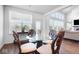 Bright dining area with glass-top table and four ornate chairs at 4416 Voyageur Way, Carmel, IN 46074