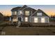 Two-story house with gray siding, brick accents, and a landscaped lawn at 4416 Voyageur Way, Carmel, IN 46074
