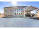 House exterior with covered patio and snowy yard at 4416 Voyageur Way, Carmel, IN 46074