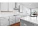 Modern kitchen with white cabinets, quartz countertops, and a gas cooktop at 4416 Voyageur Way, Carmel, IN 46074