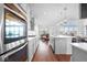 Modern kitchen with white cabinets, quartz countertops, and island at 4416 Voyageur Way, Carmel, IN 46074