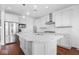 Modern kitchen with white cabinets, quartz countertops, and stainless steel appliances at 4416 Voyageur Way, Carmel, IN 46074