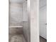 Walk-in shower with gray tile, built-in seat, and penny round flooring at 4416 Voyageur Way, Carmel, IN 46074