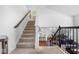 Carpeted staircase leading to the upper level, overlooking living room and kitchen at 4416 Voyageur Way, Carmel, IN 46074