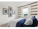 Bedroom with a blue and white bedding set and wood accent wall at 5904 Sunstone Rd, Indianapolis, IN 46239