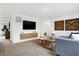Cozy bonus room with sectional sofa, wood accent wall, and large TV at 5904 Sunstone Rd, Indianapolis, IN 46239
