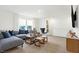 Spacious bonus room with a sectional sofa, a coffee table, and two ottomans at 5904 Sunstone Rd, Indianapolis, IN 46239