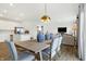 Open concept dining room with kitchen views and a large wood table at 5904 Sunstone Rd, Indianapolis, IN 46239