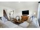Spacious living room featuring a sectional sofa, coffee table, and built-in entertainment center at 5904 Sunstone Rd, Indianapolis, IN 46239