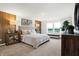 Main bedroom with a king-size bed, wood accent wall, and plenty of natural light at 5904 Sunstone Rd, Indianapolis, IN 46239