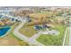 Aerial view of a residential neighborhood with tree-lined streets and ponds at 6403 Rippling Rock Dr, Plainfield, IN 46168