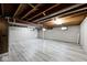 Finished basement with light gray plank floors, exposed ceiling, and painted walls at 6826 E 65Th St, Indianapolis, IN 46220