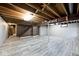 Spacious finished basement featuring light gray plank floors and exposed beams at 6826 E 65Th St, Indianapolis, IN 46220