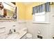 Quaint bathroom featuring a sink with a marble countertop, window and mirror at 6826 E 65Th St, Indianapolis, IN 46220