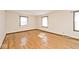 Bright bedroom with hardwood floors, two windows, and a neutral color scheme at 6826 E 65Th St, Indianapolis, IN 46220