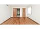 Bedroom featuring hardwood floors, natural light, and closet space at 6826 E 65Th St, Indianapolis, IN 46220