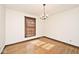 Dining room features a chandelier and hardwood floors, creating a bright and inviting ambiance at 6826 E 65Th St, Indianapolis, IN 46220
