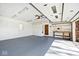 Bright garage space with painted floor, ample lighting, and an organizational pegboard, ideal for hobbies and projects at 6826 E 65Th St, Indianapolis, IN 46220