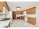 Functional kitchen with classic wood cabinets and white appliances, offering ample storage space at 6826 E 65Th St, Indianapolis, IN 46220