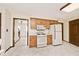 The kitchen features classic wood cabinets, white appliances, and an adjacent staircase at 6826 E 65Th St, Indianapolis, IN 46220