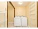 Bright laundry room with appliances and shelving, offering convenience and organization at 6826 E 65Th St, Indianapolis, IN 46220