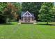 Charming backyard cottage with a swing and beautifully landscaped yard at 7837 Dean Rd, Indianapolis, IN 46240