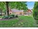 Spacious backyard with stone patio, screened-in porch, and lush landscaping perfect for entertaining at 7837 Dean Rd, Indianapolis, IN 46240