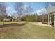 Lush backyard with a stone firepit and outdoor seating area, offering a relaxing and inviting outdoor space at 7837 Dean Rd, Indianapolis, IN 46240
