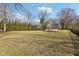 Spacious backyard with well-maintained lawn and mature trees, providing a serene and private outdoor setting at 7837 Dean Rd, Indianapolis, IN 46240