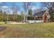 Expansive backyard featuring a charming structure with swing, firepit, and manicured lawn, perfect for outdoor enjoyment at 7837 Dean Rd, Indianapolis, IN 46240