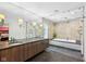 Modern bathroom features a double vanity, glass shower, and a soaking tub at 7837 Dean Rd, Indianapolis, IN 46240