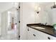 Bright bathroom with a marble countertop vanity, modern lighting, and a view into the hallway at 7837 Dean Rd, Indianapolis, IN 46240