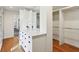 Dressing area featuring built-in storage, white cabinets, and hardwood floors at 7837 Dean Rd, Indianapolis, IN 46240
