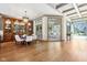 Elegant dining area with a built-in cabinet and view into a sunroom with plenty of natural light at 7837 Dean Rd, Indianapolis, IN 46240