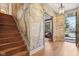 Bright entryway boasts unique tree-themed mural, hardwood floors, and staircase to the left at 7837 Dean Rd, Indianapolis, IN 46240