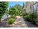 Stone pathway leading to the exterior, featuring manicured landscaping with flowers and greenery at 7837 Dean Rd, Indianapolis, IN 46240