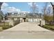 Stone home offers three-car garage, dormer windows, manicured lawn, and symmetrical design for classic curb appeal at 7837 Dean Rd, Indianapolis, IN 46240