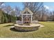 Charming firepit with surrounding stone seating and swing, great for cozy evenings and outdoor gatherings at 7837 Dean Rd, Indianapolis, IN 46240