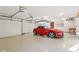 Well-lit garage with a clean epoxy floor, high ceilings, and a red sports car at 7837 Dean Rd, Indianapolis, IN 46240