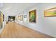 Bright hallway featuring a collection of artwork displayed on the walls with track lighting at 7837 Dean Rd, Indianapolis, IN 46240