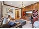 Inviting living room features custom wood built-ins, a large leather sofa, and a decorative chandelier at 7837 Dean Rd, Indianapolis, IN 46240