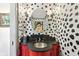 Unique powder room with striking Dalmatian-print wallpaper and a red vanity at 7837 Dean Rd, Indianapolis, IN 46240