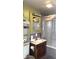 Small bathroom with a tub, wooden vanity, and a medicine cabinet at 917 E 34Th St, Indianapolis, IN 46205