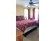 Bedroom with a queen bed, red bedding, and a chaise lounge at 917 E 34Th St, Indianapolis, IN 46205